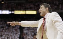 Louisville coach Rick Pitino makes a point to his players during the first half of their NCAA college basketball game against Pittsburgh in Louisville, Ky., Sunday, Feb. 27, 2011. (AP Photo/Ed Reinke)